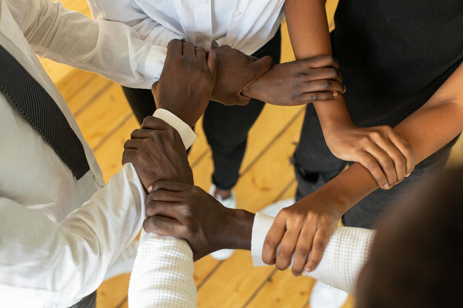 close up of people holding arms